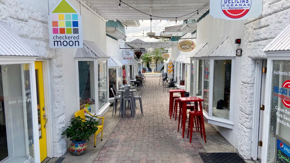 A cobblestone street lined with local shops in downtown Mount Dora, just minutes from Elevate 155 Apartments.
