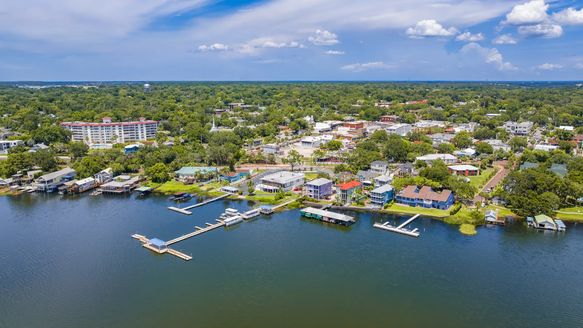 Aerial image of Mount Dora, Florida with a clear view of the lakefront, residential areas, and downtown district.