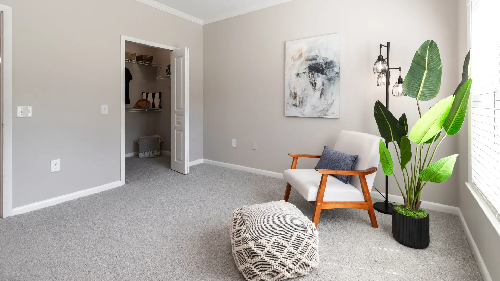 Bedroom with gray carpet, natural light, and a walk-in closet featuring built-in shelving at Elevate 155.