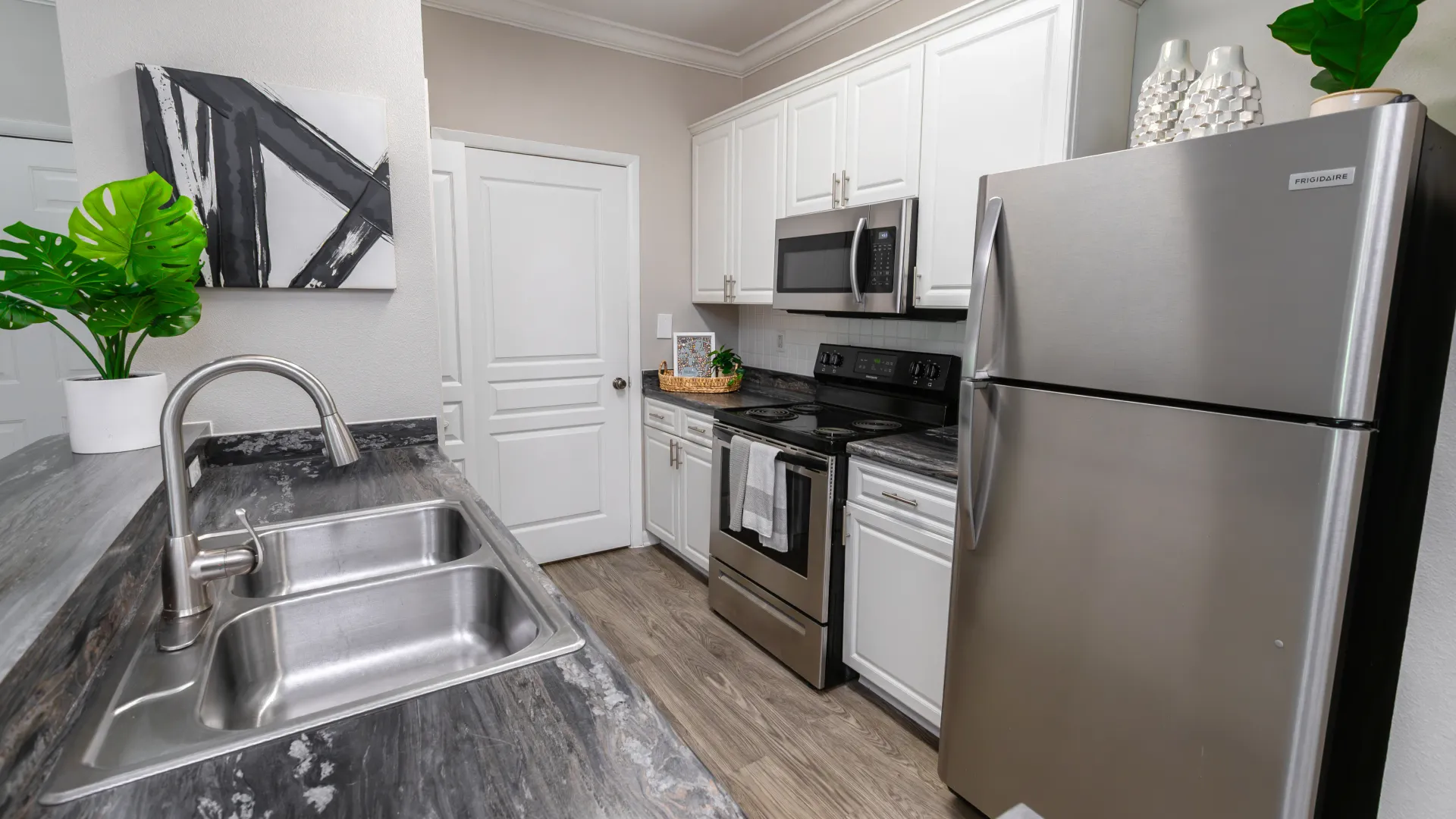 Kitchen interior with stainless steel appliances and modern finishes at Elevate 155 apartments.
