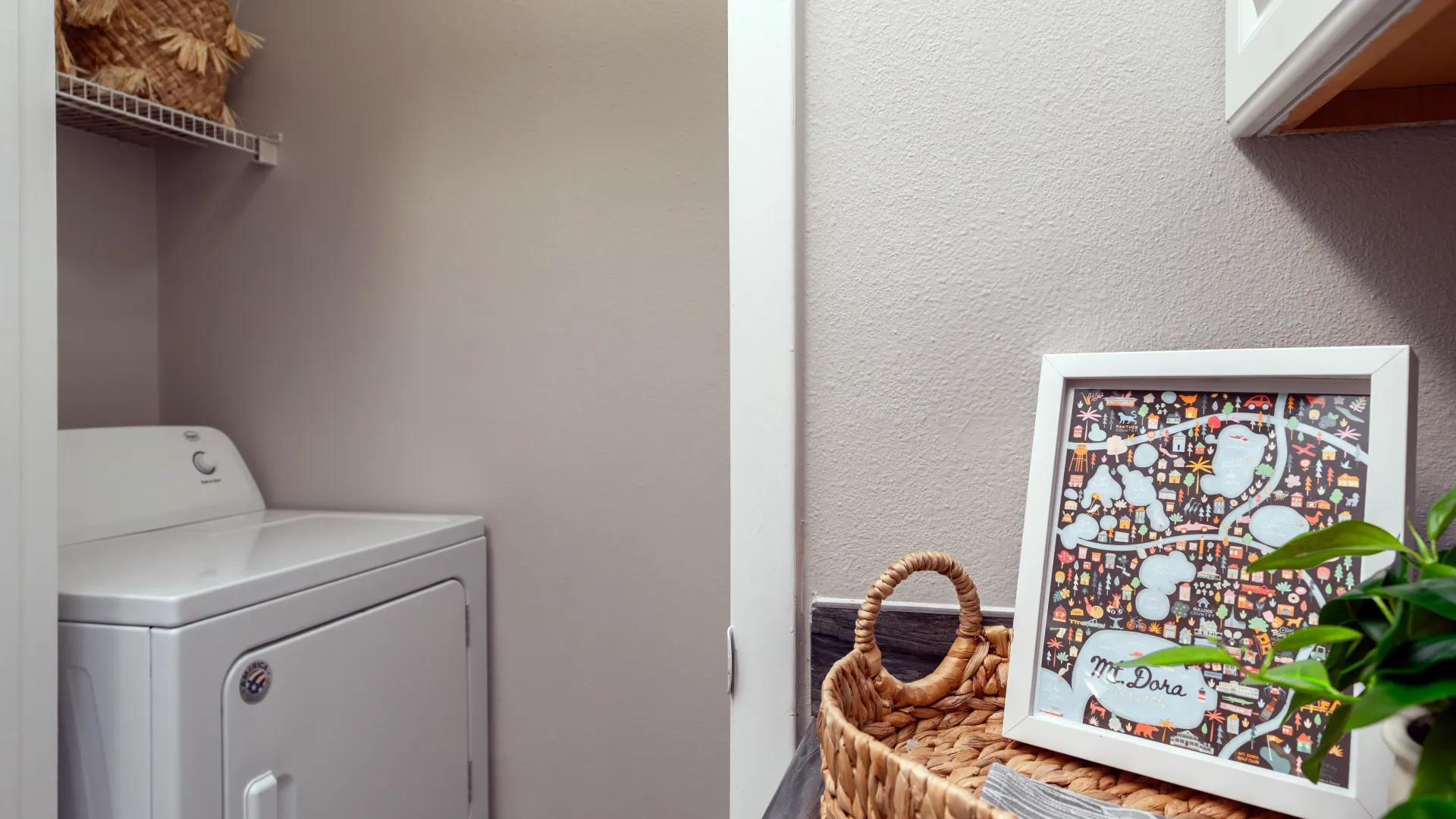In-home laundry area with full-size washer and dryer at Elevate 155.