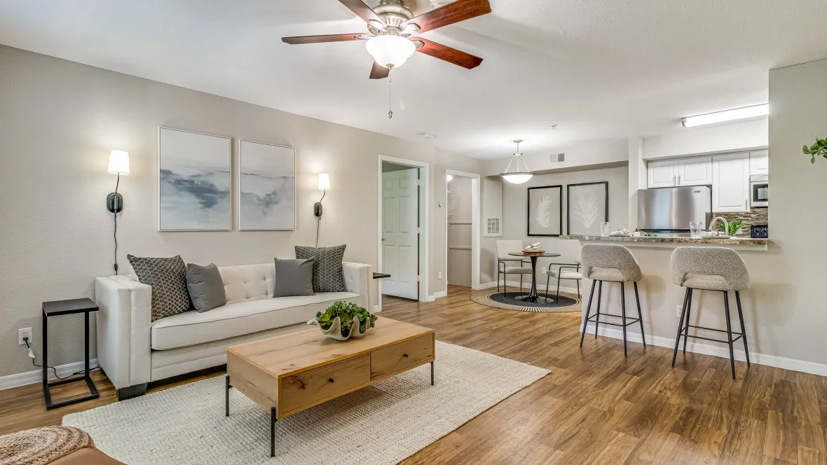 A connected living space with open access between the kitchen, dining, and living areas, featuring gorgeous wood-style flooring.