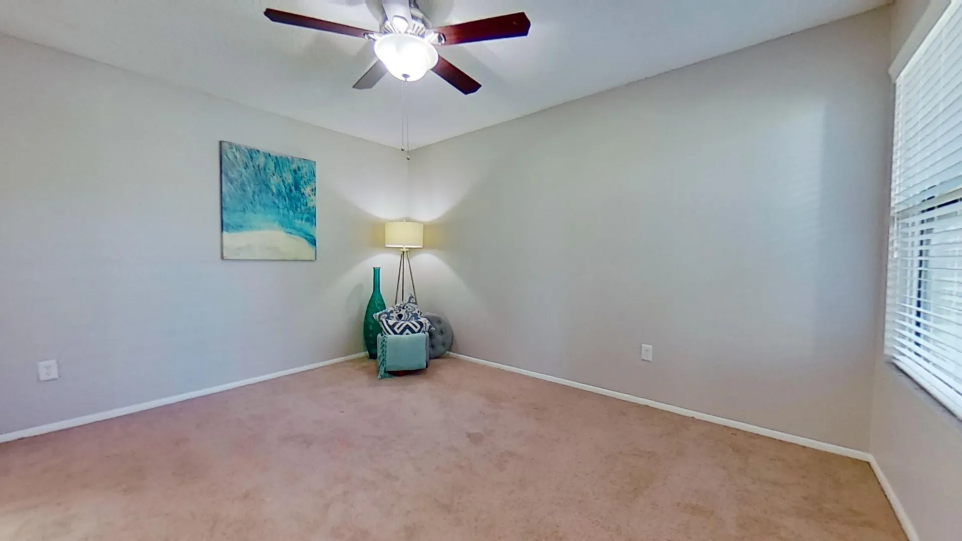 Bedroom with carpet flooring and ceiling fan in The Newport Autograph floor plan at River Reach Apartments.