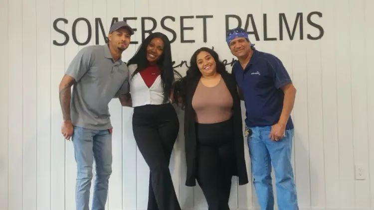 A group shot of the leasing and maintenance staff members at Somerset Palms Apartments