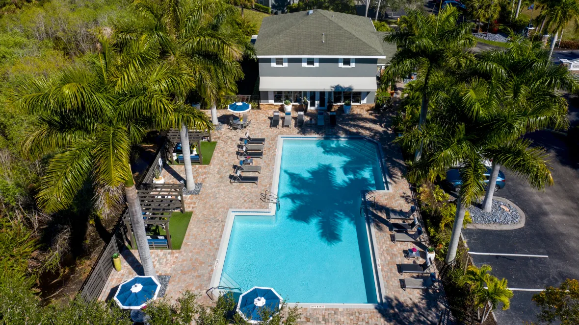 A captivating bird's eye view showcasing the sparkling swimming pool and expansive sundeck 