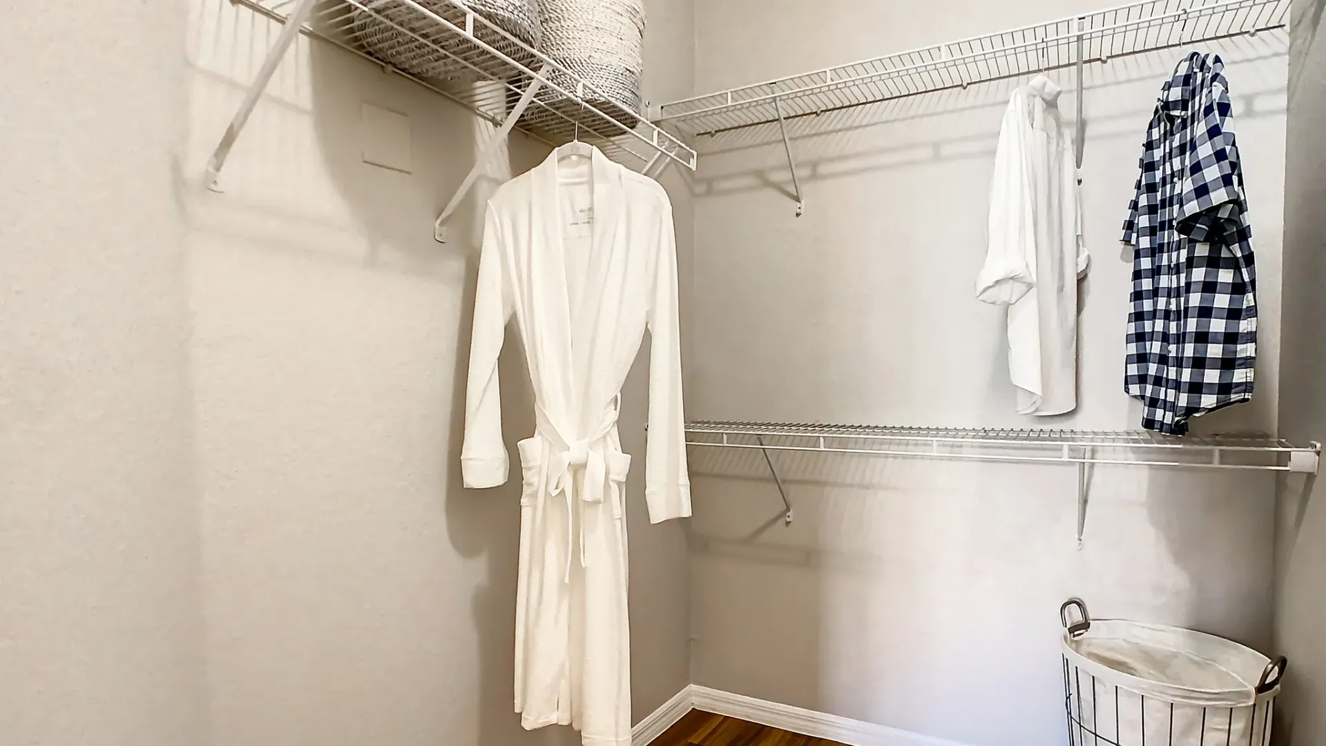 A walk-in closet with staggered shelves for organization 