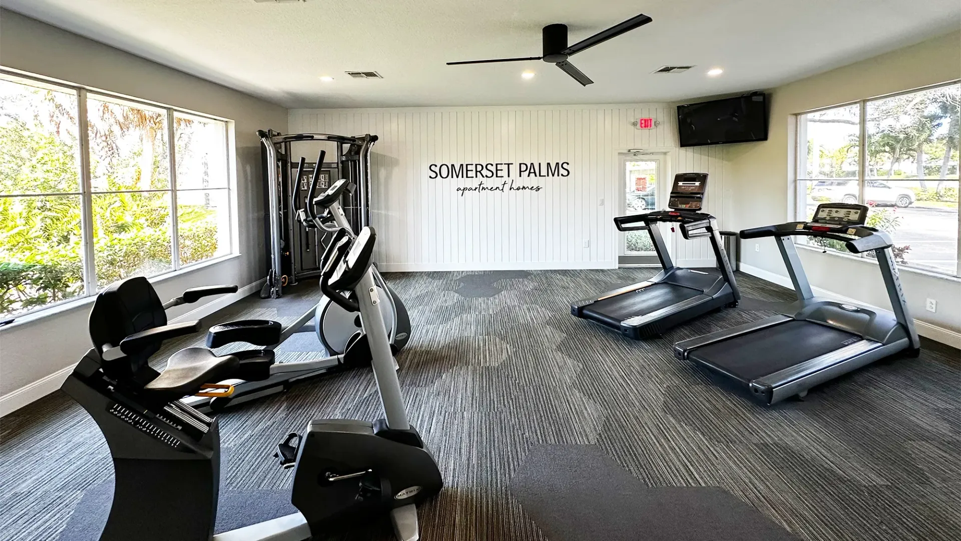A fitness center with cardio and weight equipment