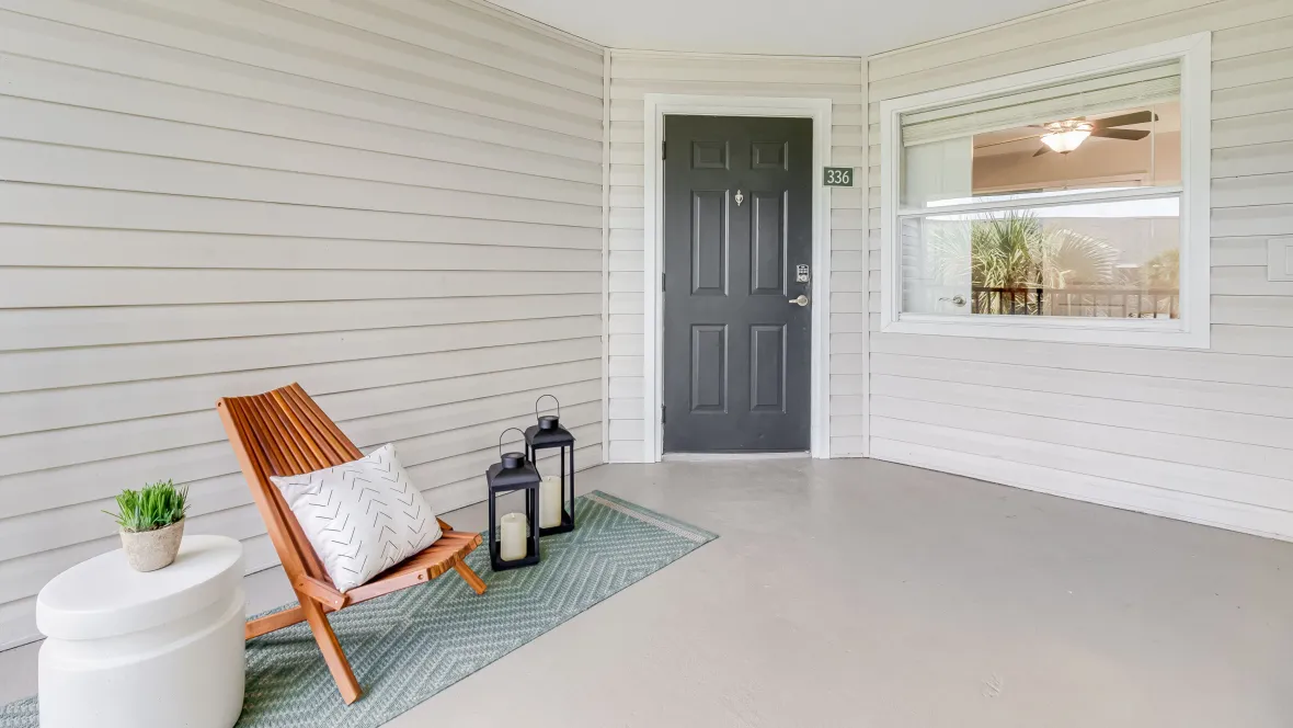 A massive, private screened lanai just outside of an apartment front door that is a blank canvas.
