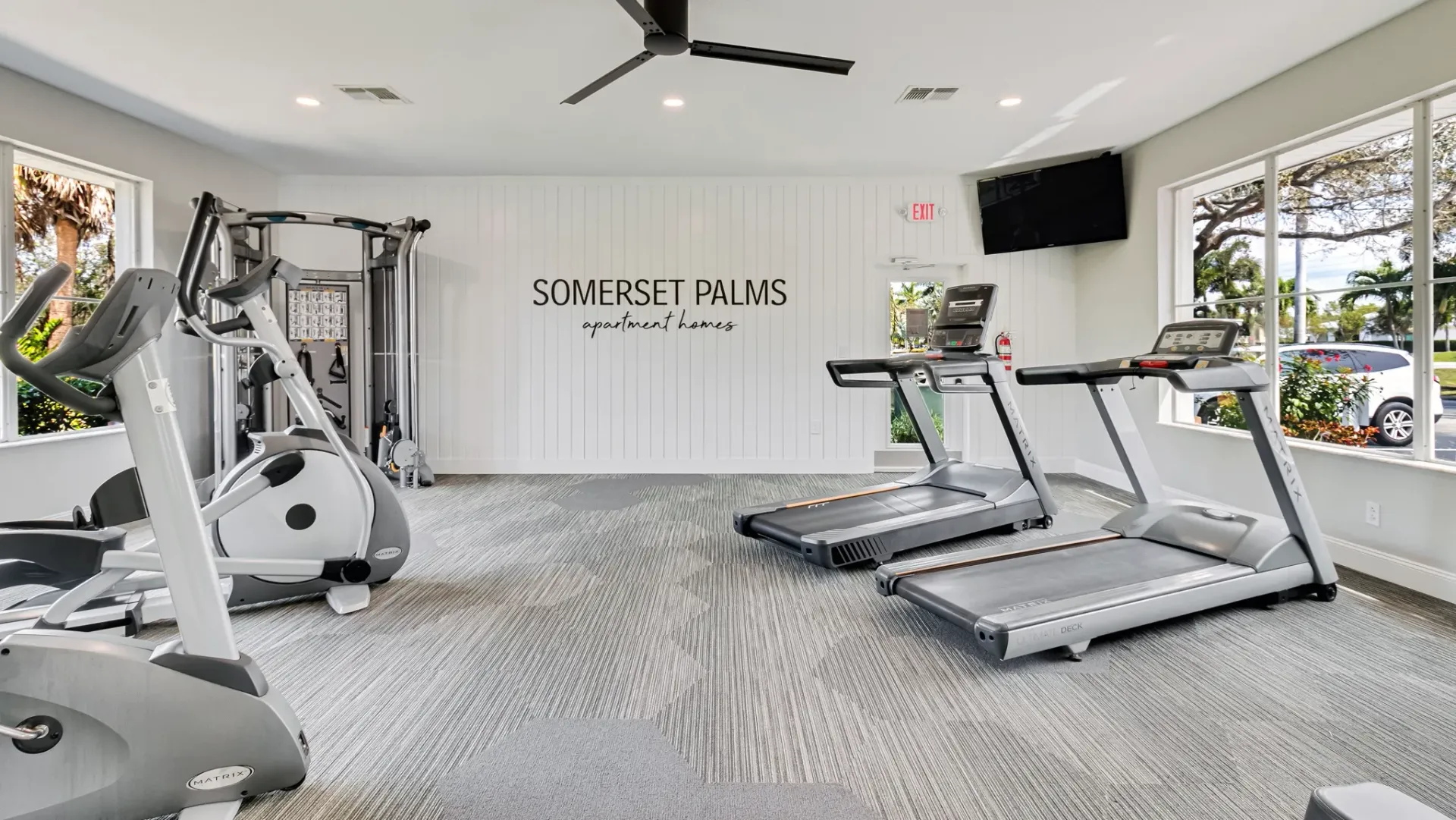 A bright, modern fitness center fully equipped with cardio and weight equipment