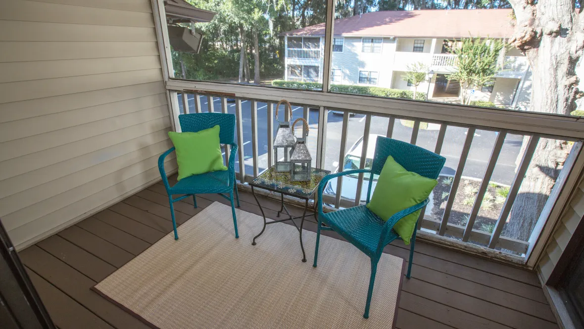 An oversized balcony adorned with charming chairs and a side table, a personal oasis to indulge in outdoor living.