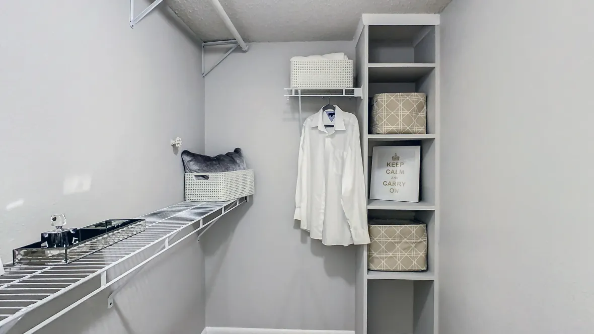 A large closet with multiple hanging and shelving options built-in.
