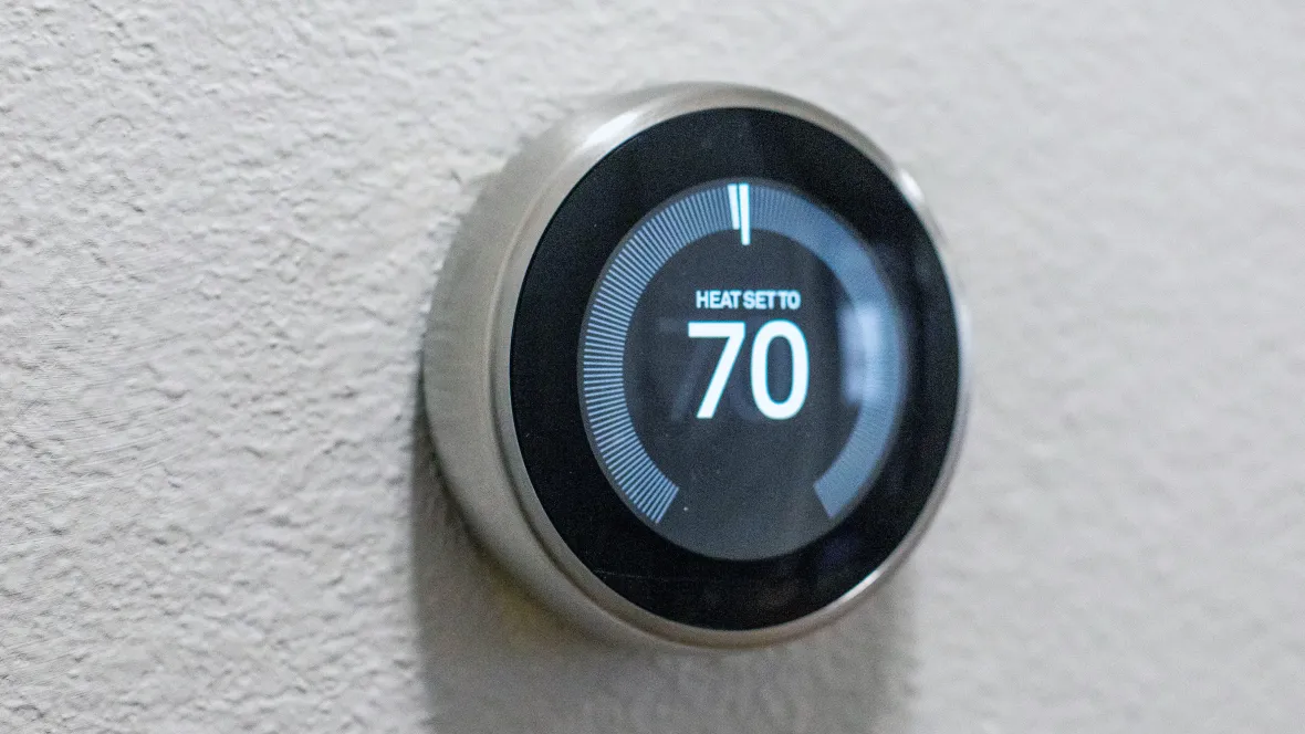 A Nest brand smart thermostat.