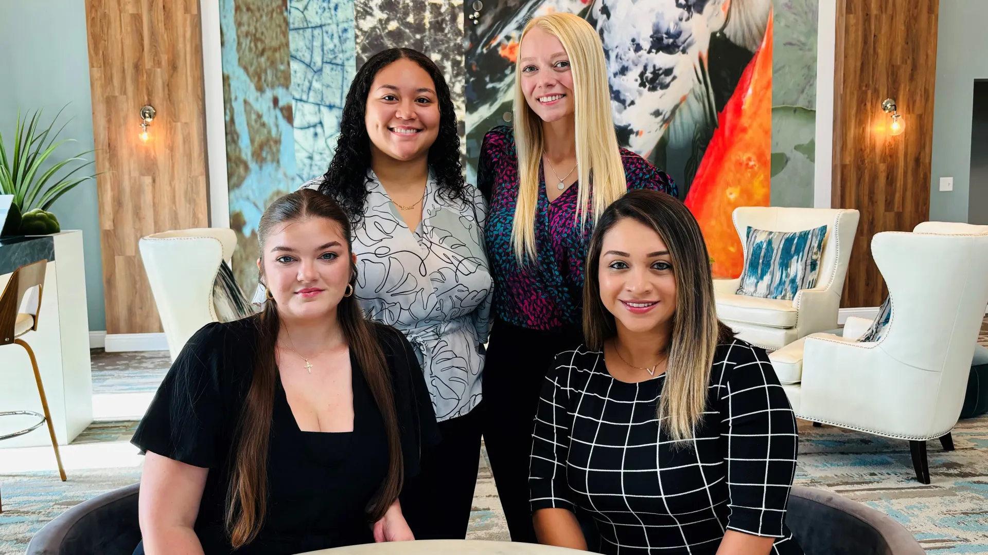 The leasing office staff posing in the leasing office