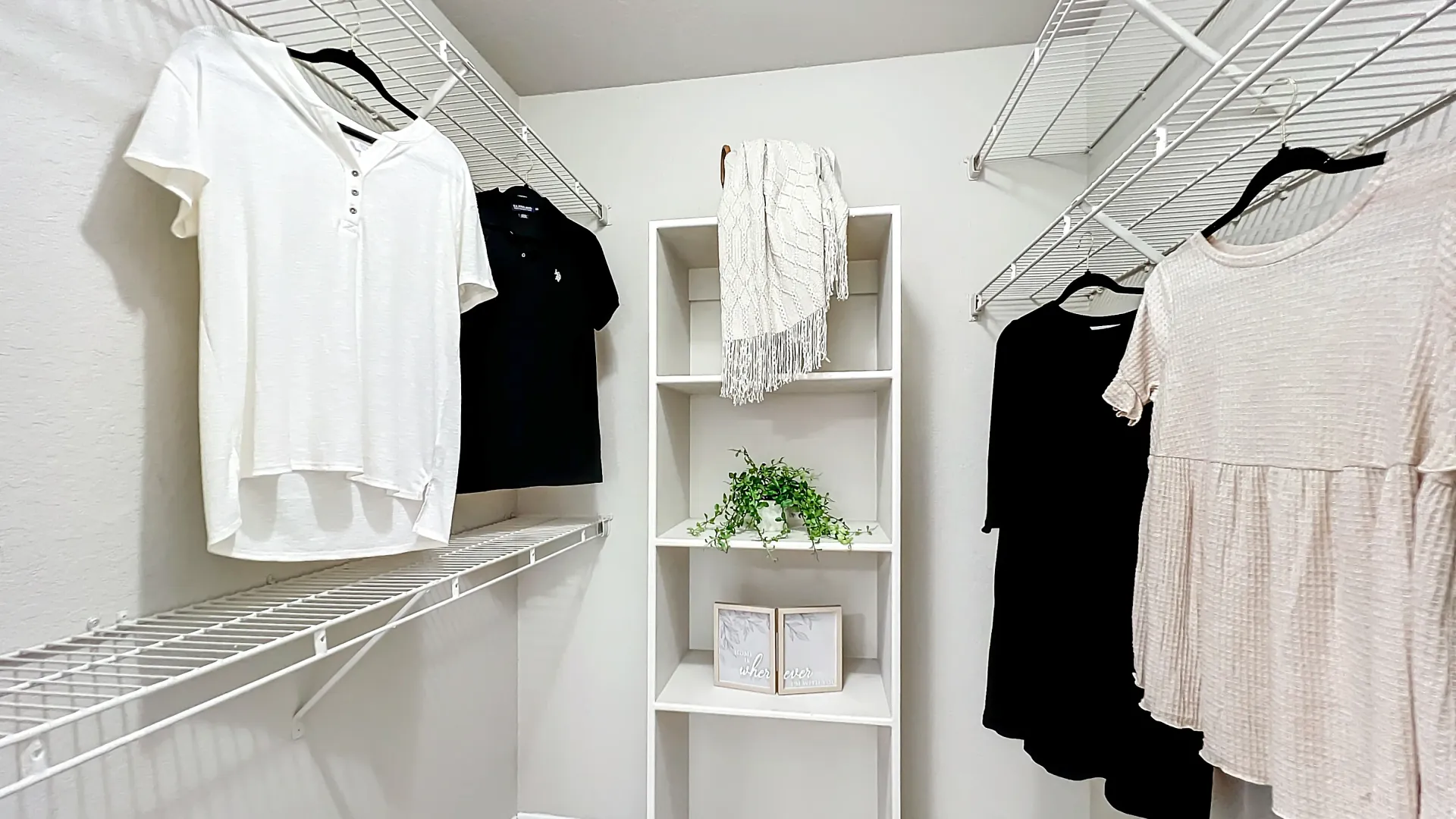 Spacious walk-in closet with modern shelving and hanging clothes.