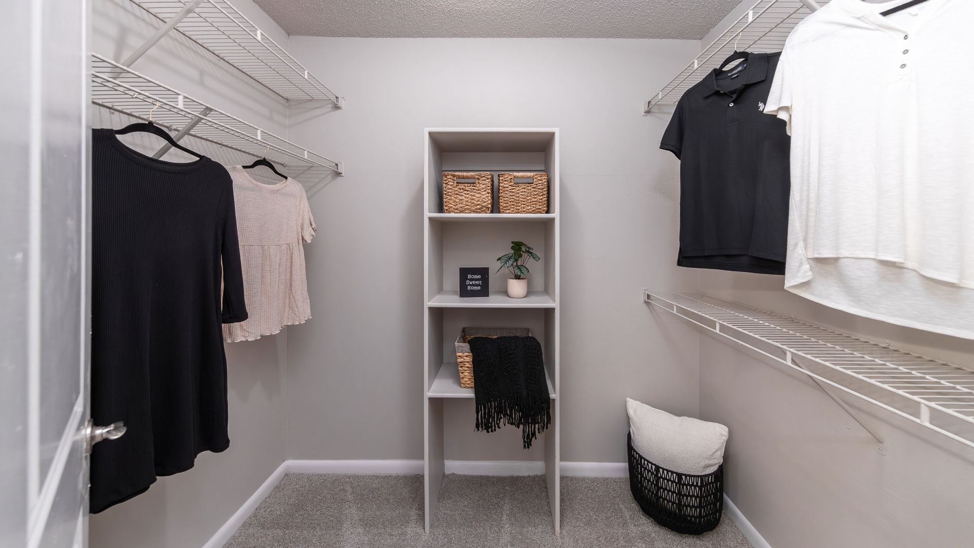 Walk-in closet with wire shelving and built-in organizer at Harper Grand Apartments in Orlando, Florida.