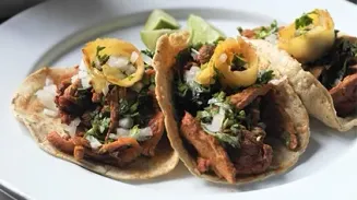 A plate of tacos on a restaurant table