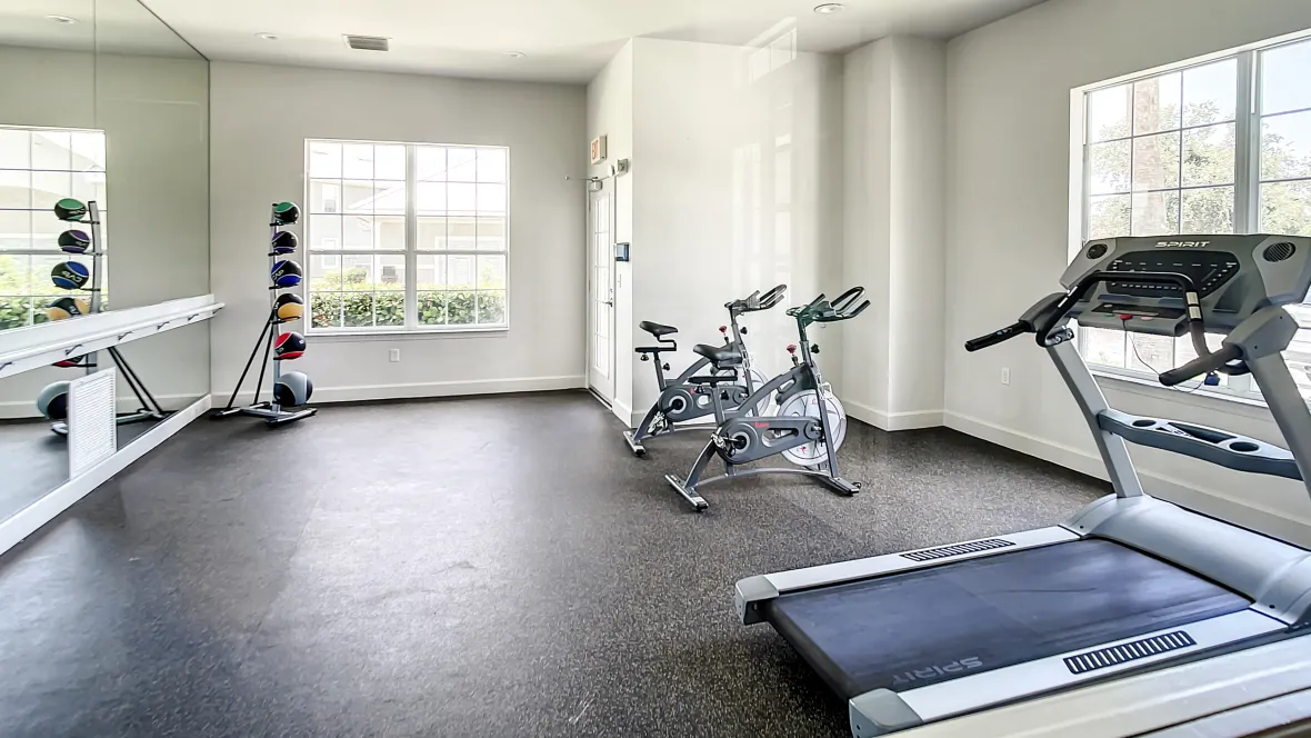 Charleston Cay's gym features floor-to-ceiling fitness mirrors, medicine balls, and cardio equipment