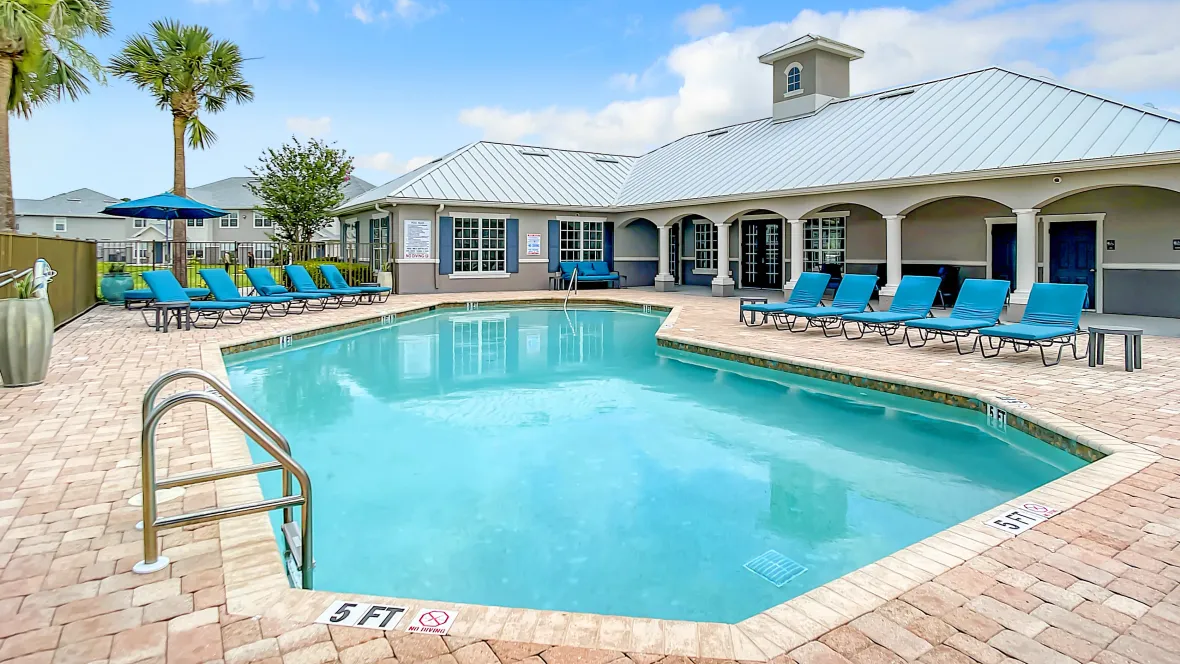 A refreshing, sparkling pool surrounded by a sundeck, creating an oasis for relaxation.
