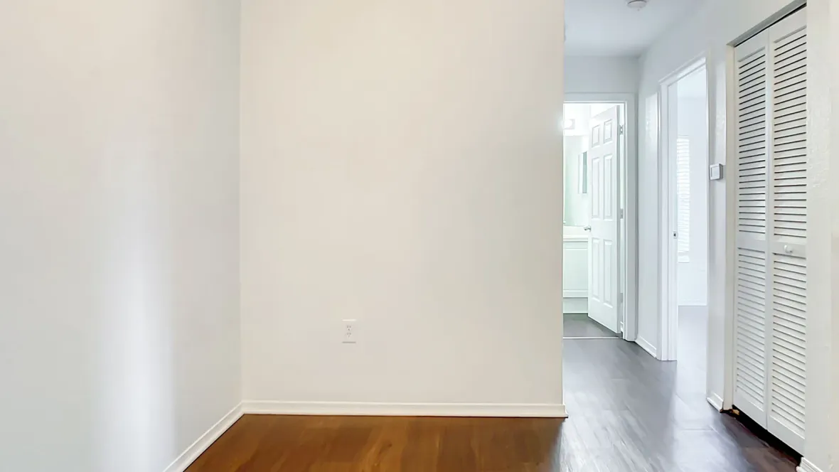 A hallway with wood-style flooring throughout