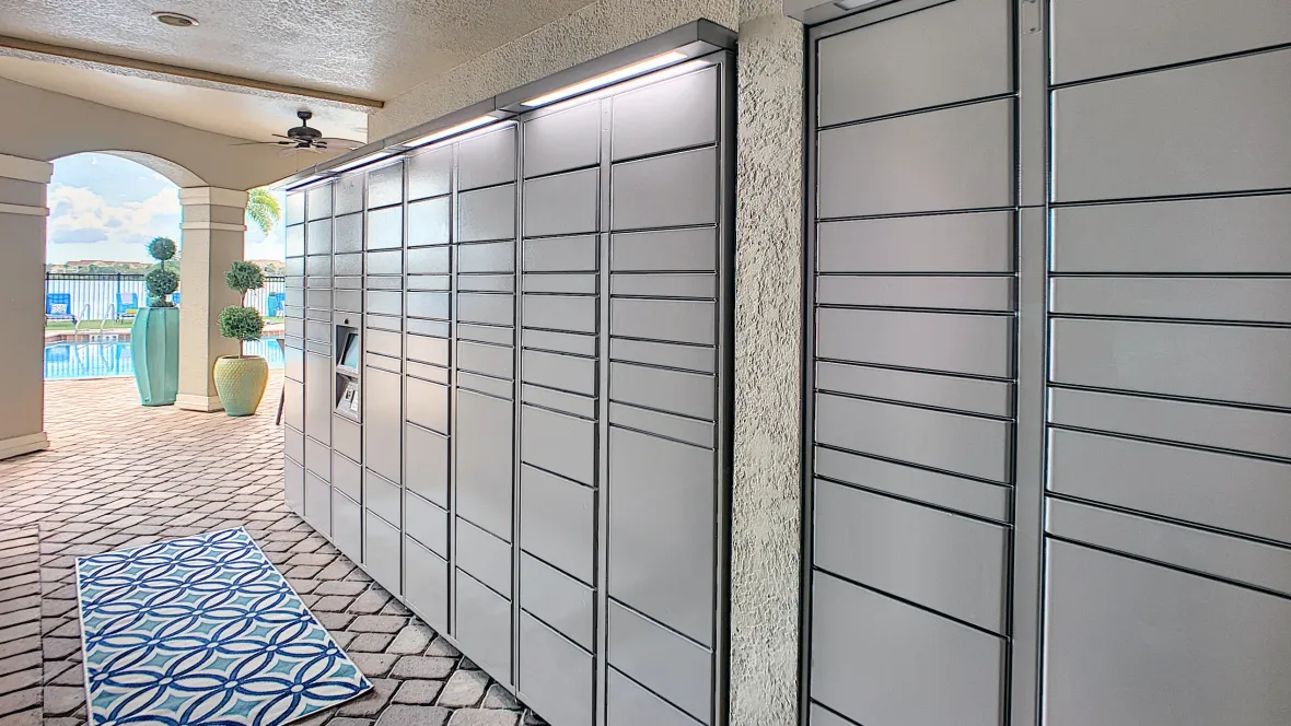An array of Amazon package lockers outdoors under a breezeway by the pool, providing strategic convenience for all residents.