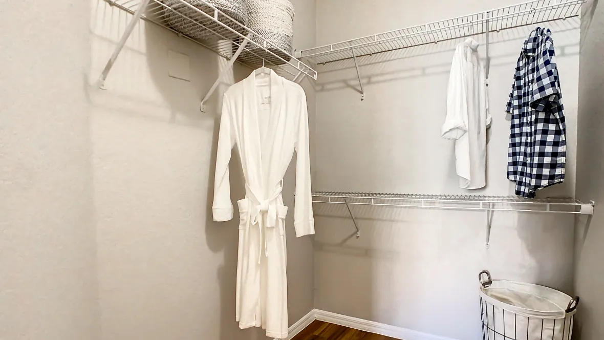 Roomy walk-in closet with wall-to-wall custom shelving – a storage enthusiast's dream.