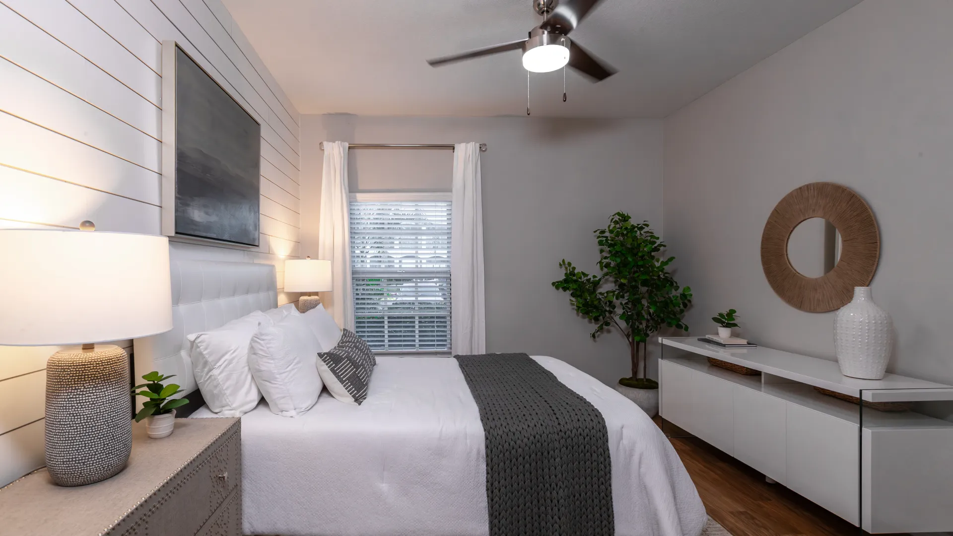 Well-designed bedroom featuring a cozy bed, statement lighting, and soft, earthy accents.