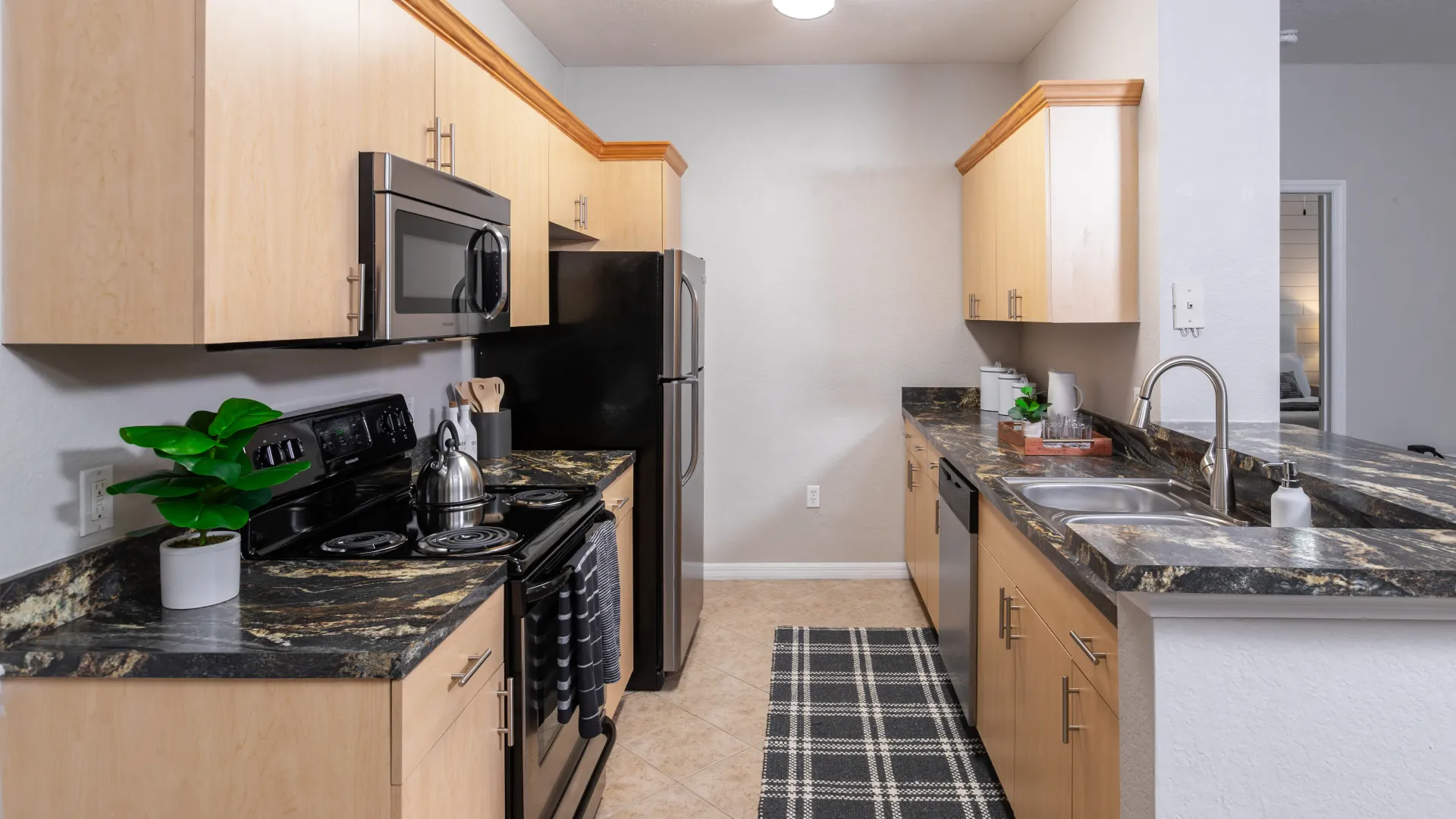 Spacious apartment kitchen with a stylish design, featuring a breakfast bar, ample cabinetry, and high-end finishes.