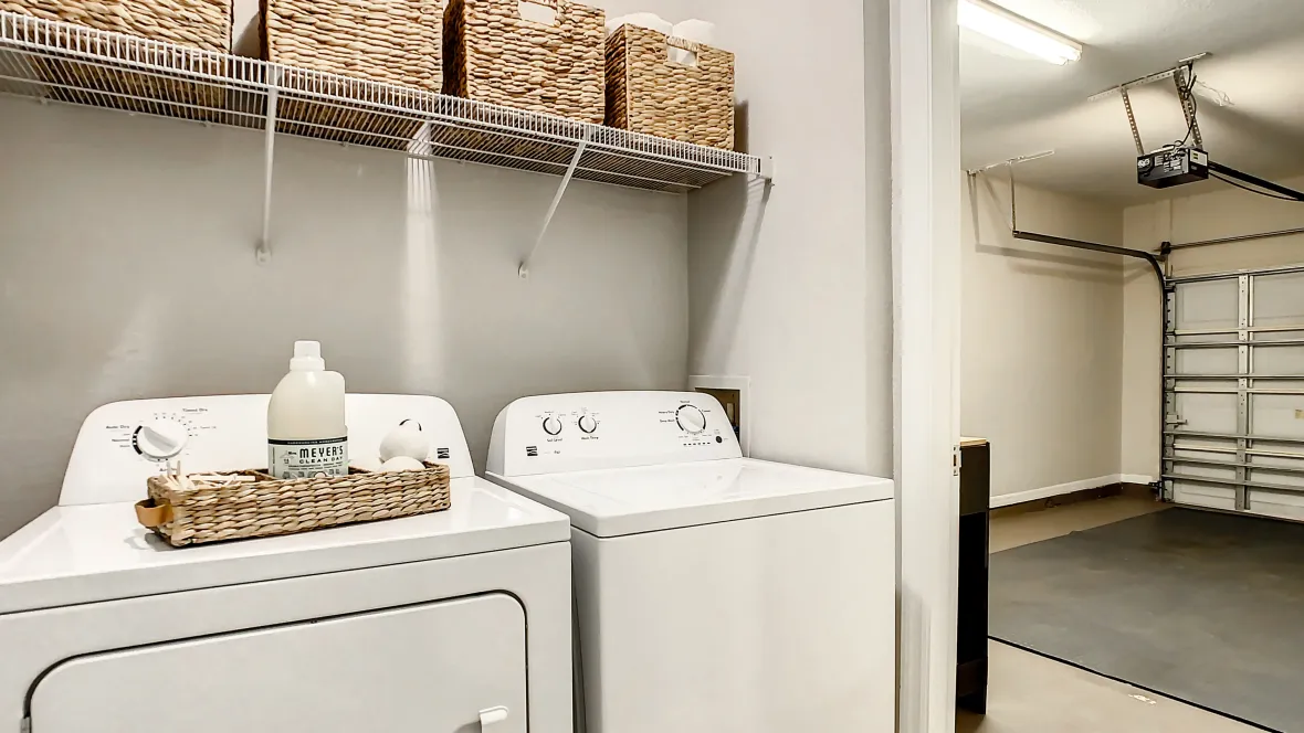 Full-size washer and dryer with additional shelving – convenience and storage in one.