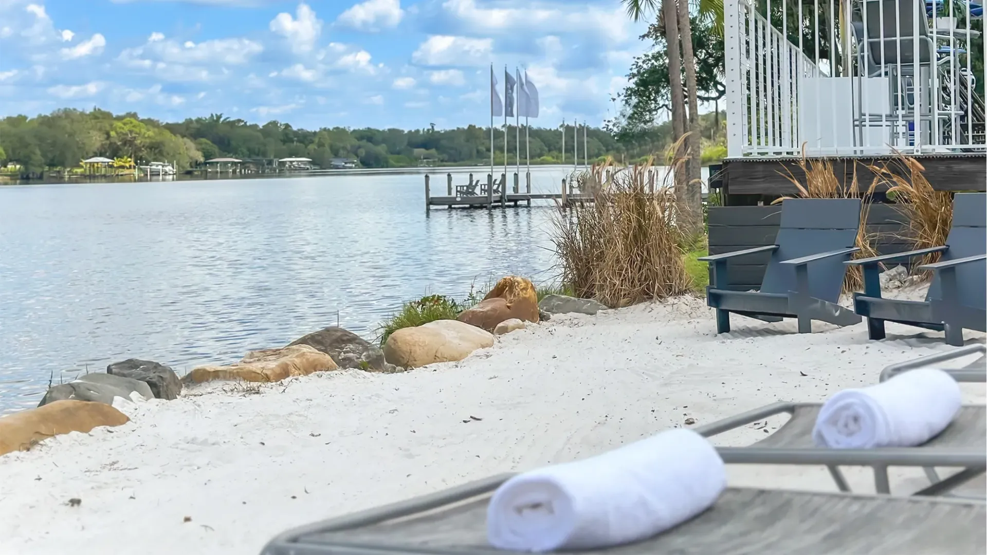 Loungers on a sandy, riverfront beach