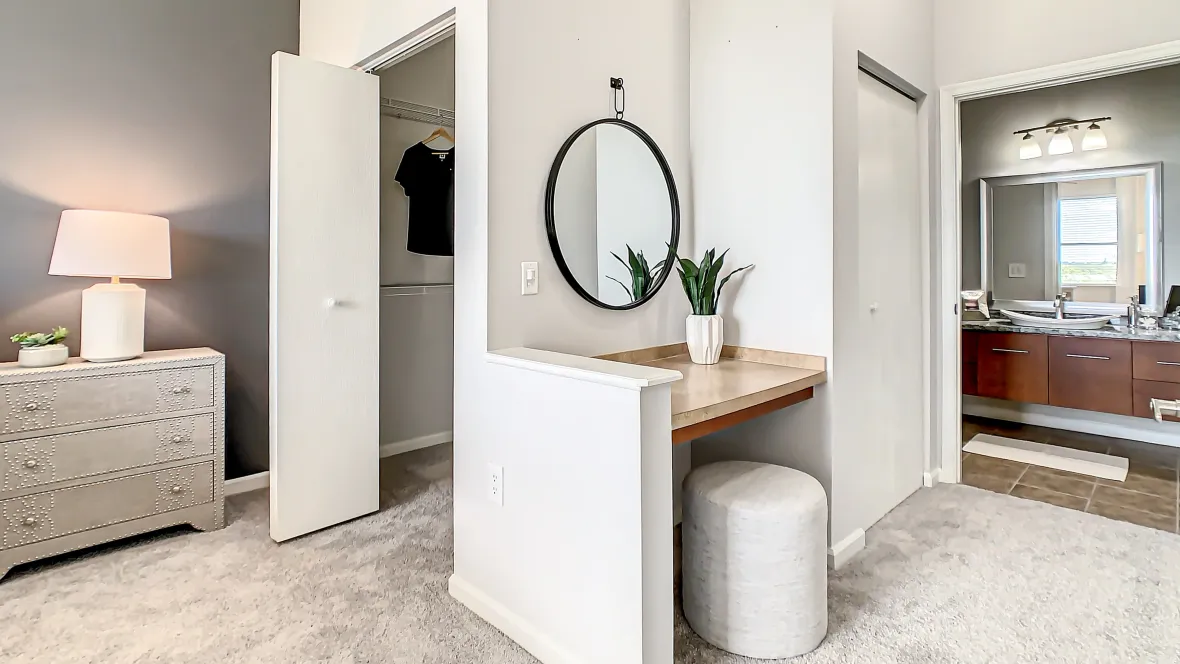 Soft, plush carpeting guides from the master bedroom through the walk-in closet and down the hall culminating at the master bathroom, with a built-in countertop in the hallway crafting a dedicated bonus vanity area.