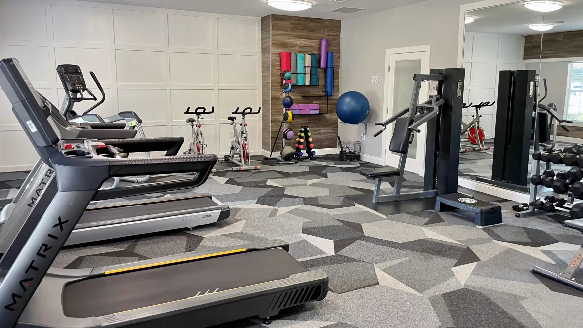 A well-equipped fitness space featuring a trove of cardio and weight training machines, offering residents an immersive fitness haven for a fulfilling workout regimen.