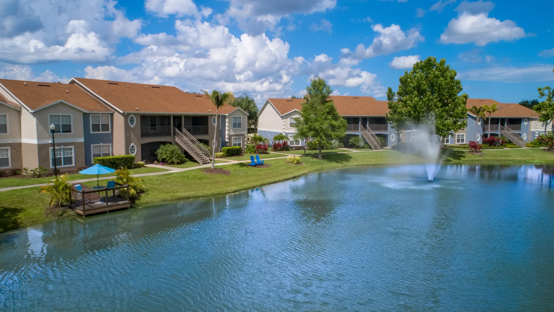 The lakeside view showcasing the community's serene surroundings, with inviting seating areas for residents to enjoy picturesque lake views year-round. 