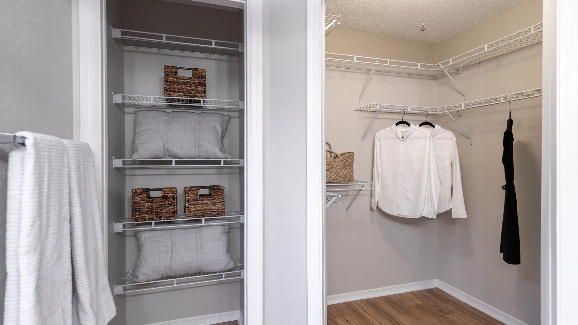 Walk-in master closet with shelving and hanging space located inside the master bathroom.