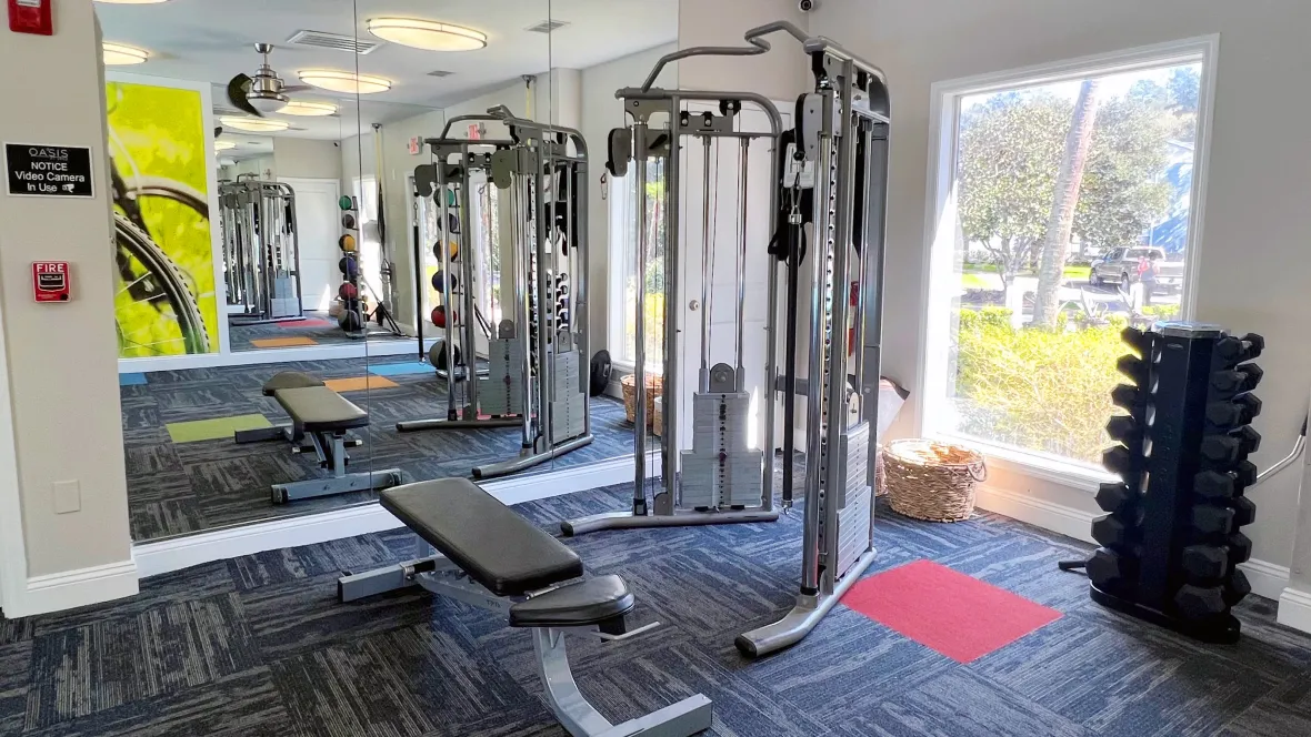 Free weights, a weight training machine, bench, and medicine balls create a strength training haven in our fitness space. 