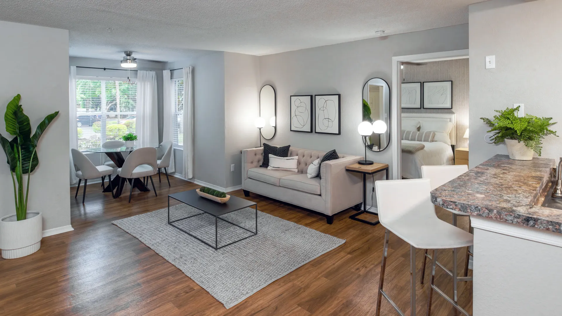 Open-concept living room with view of solarium dining space at Oasis at 1800.