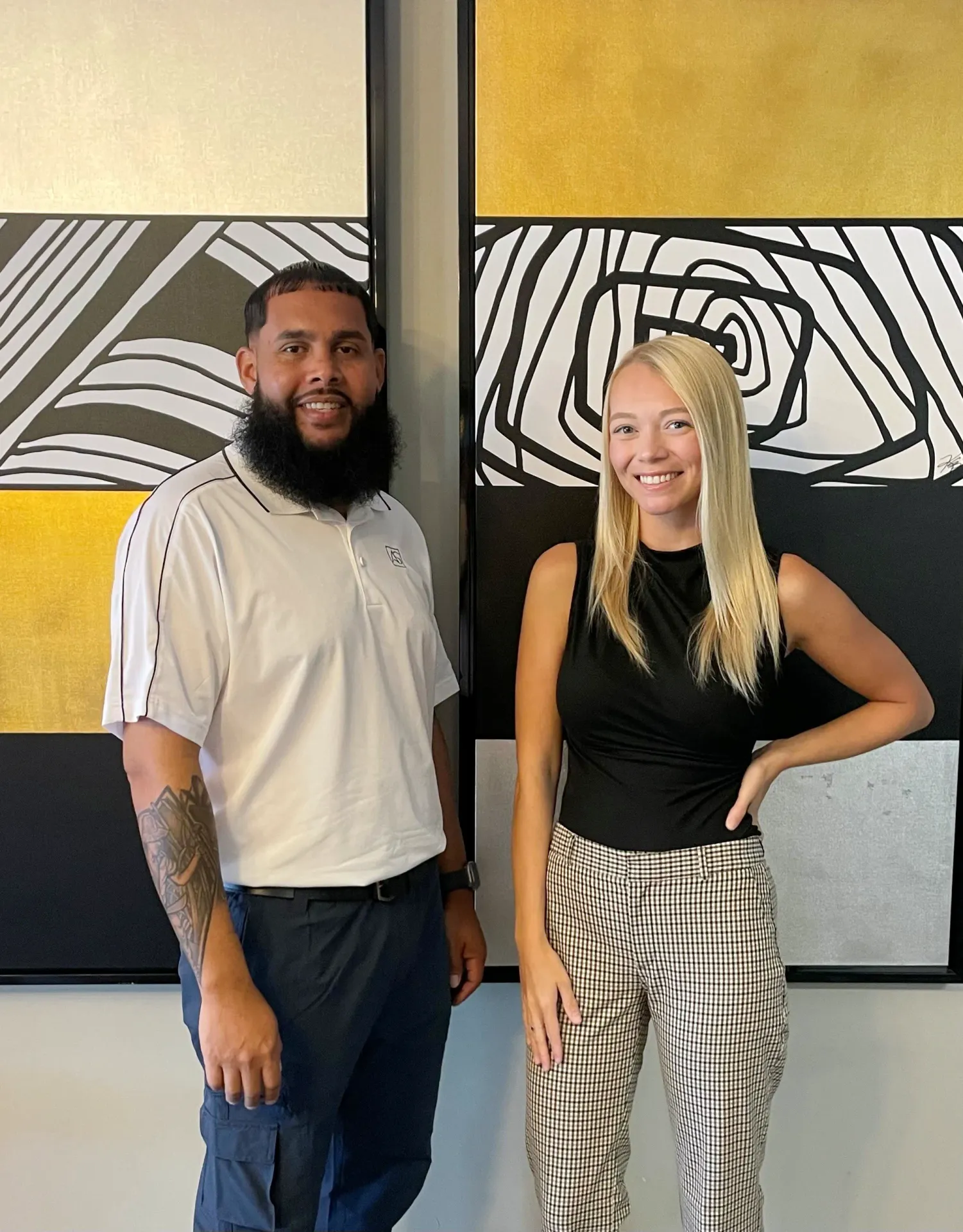 Team members at Slate standing in a modern leasing office featuring contemporary décor and decorative wall panels.