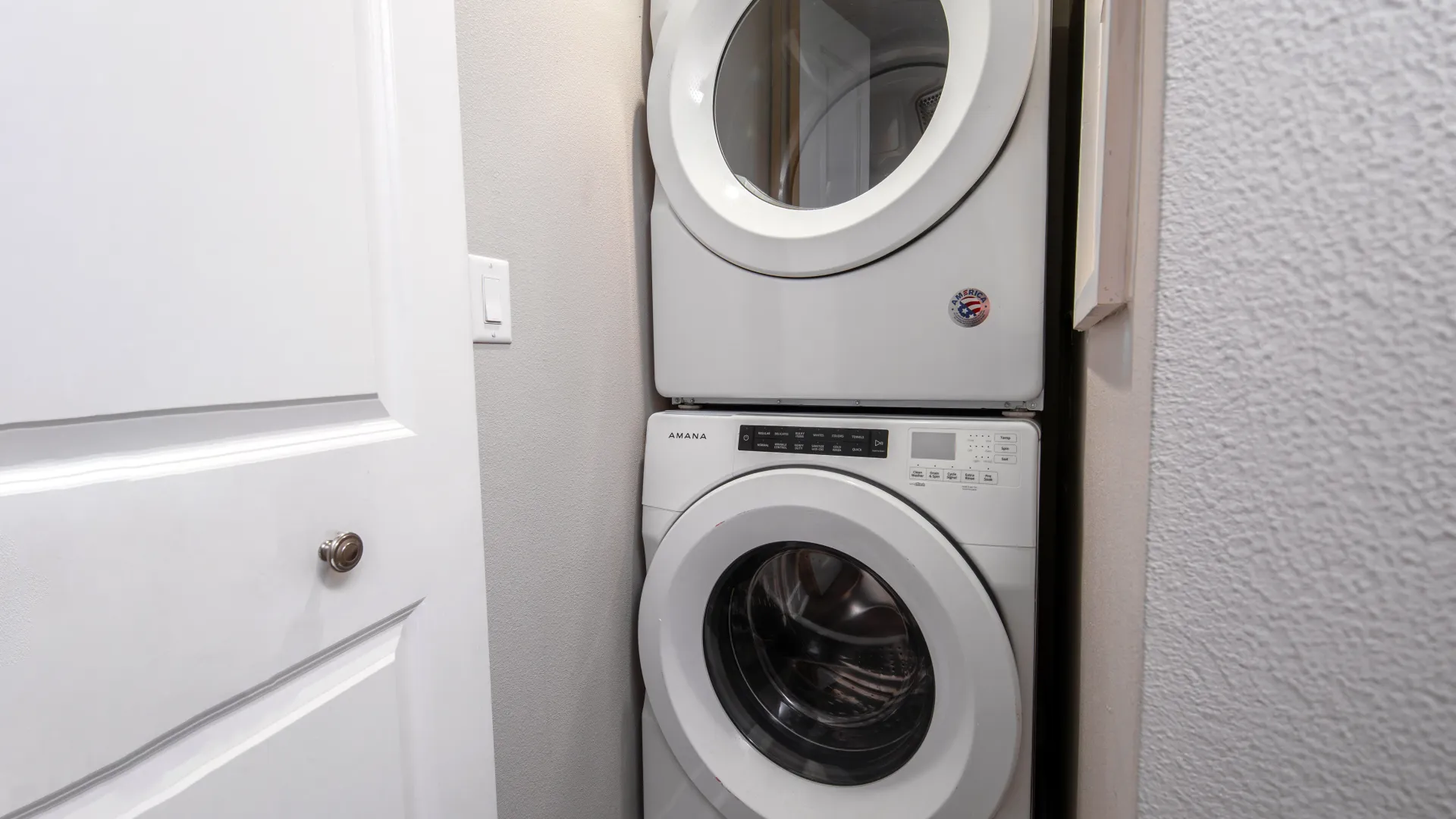 In-unit stackable washer and dryer set in a laundry nook, providing convenient laundry access for residents.