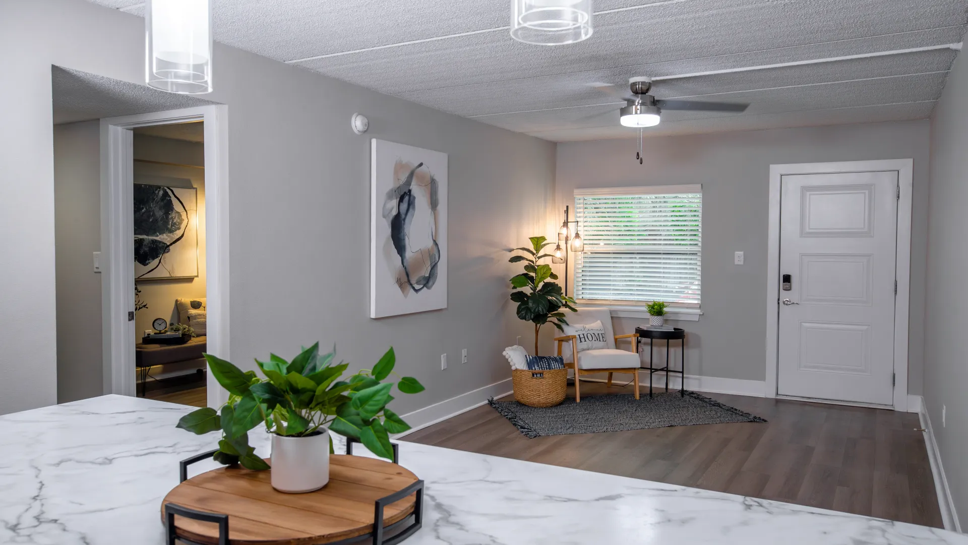 Cozy living room with modern decor, soft lighting, and comfortable seating at Elon Winter Park Apartments, offering a stylish and inviting space for residents to relax.