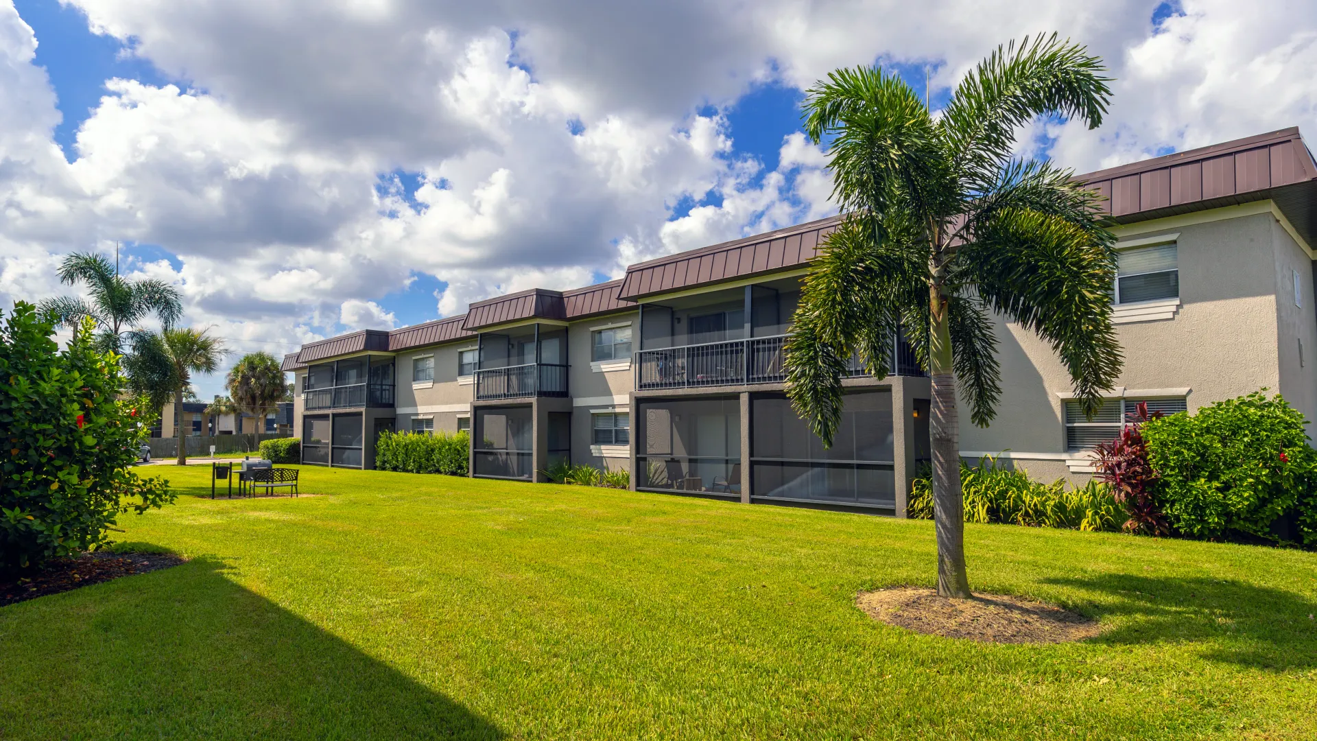 Exterior of Poste Winter Park Apartments showcasing private screened-in patios and balconies, offering residents a comfortable outdoor living space with privacy and scenic views.