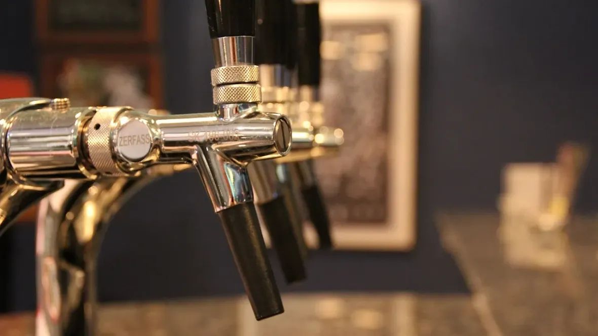 A row of beer taps at a brewery