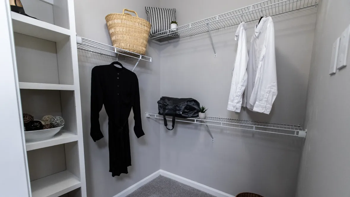  Oversized closets featuring a tailored shelving systems including a built-in bookshelf for shoes or accessories. 