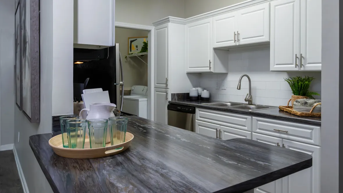 A view of the kitchen with black fusion countertops showcasing the breakfast bar.