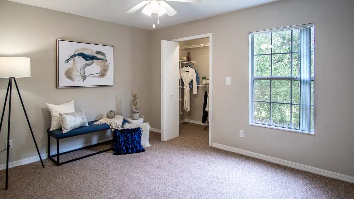 Eagle's Pointe master bedroom: a serene haven with a walk-in closet and a multi-speed ceiling fan, where comfort and style unite.