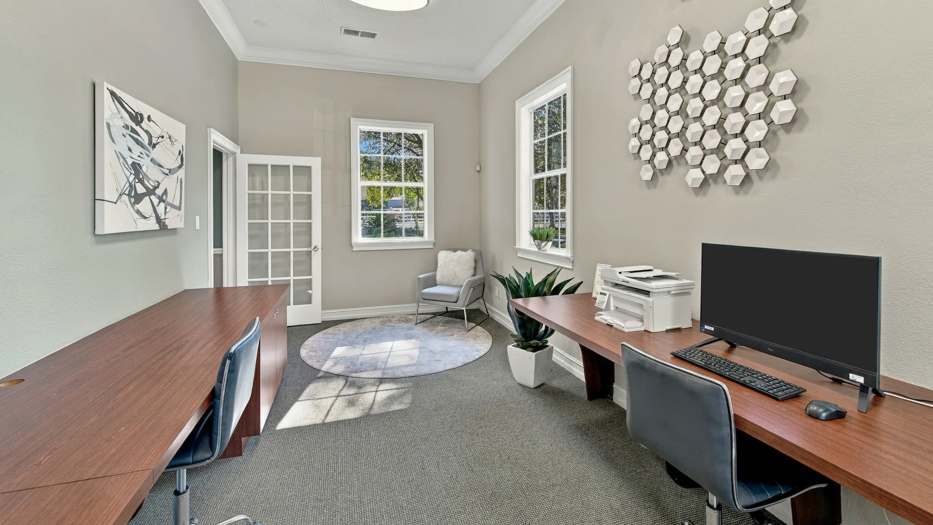 Business center at Eagle's Pointe featuring computer workstations, office desks, a printer with free printing services, and comfortable seating.