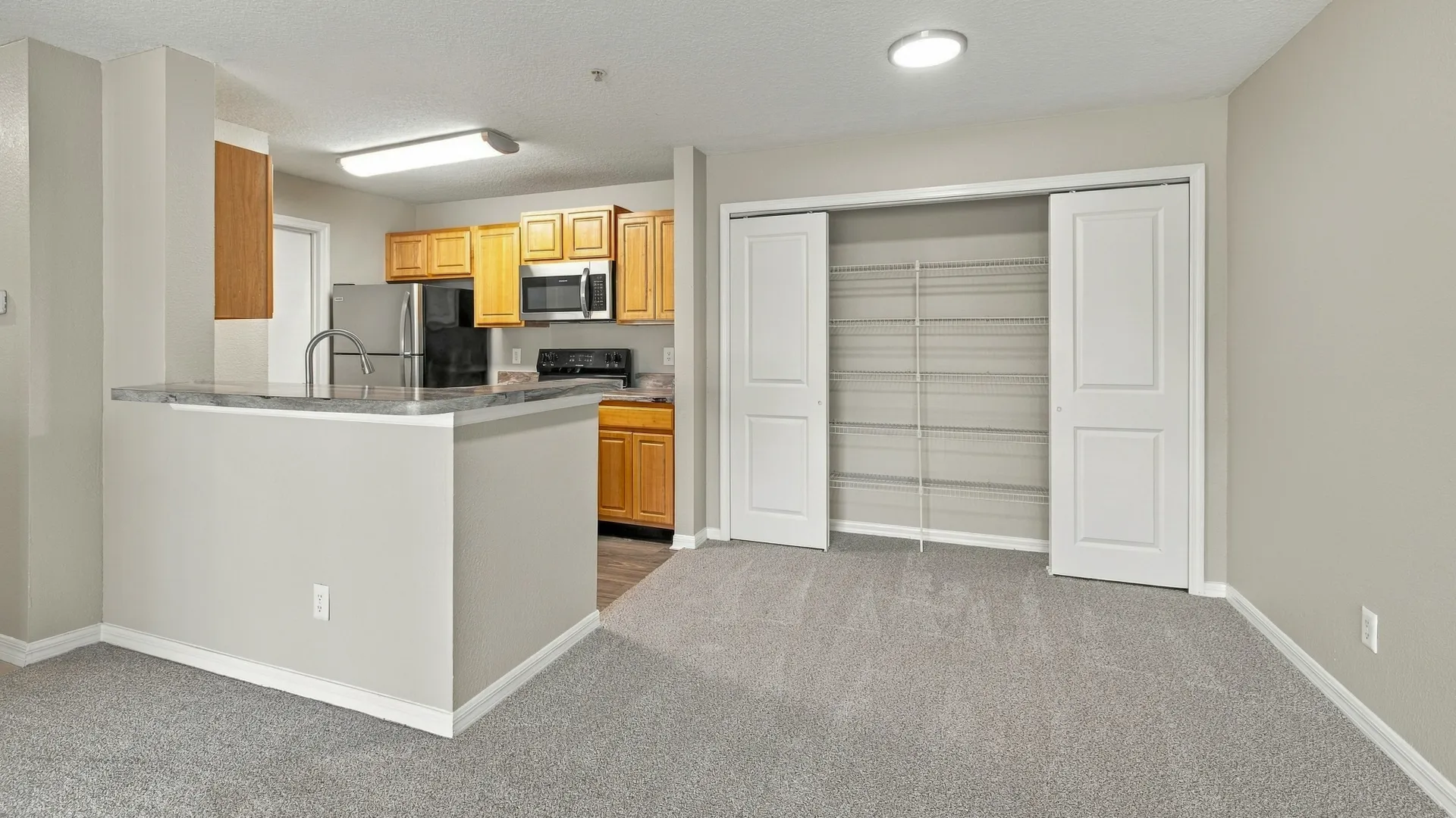 Dining area in The Port floor plan at Eagle's Pointe featuring plush carpeting, an open-concept layout, a breakfast bar, and convenient access to the kitchen.