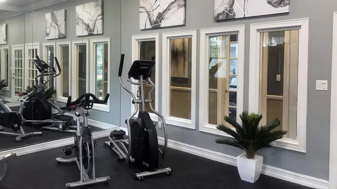 Snapshot of Eagle's Pointe fitness center, complete with an elliptical, fitness bike, weight equipment and a wall-to-wall, ceiling-to-floor mirror - everything you need to focus on your well-being.