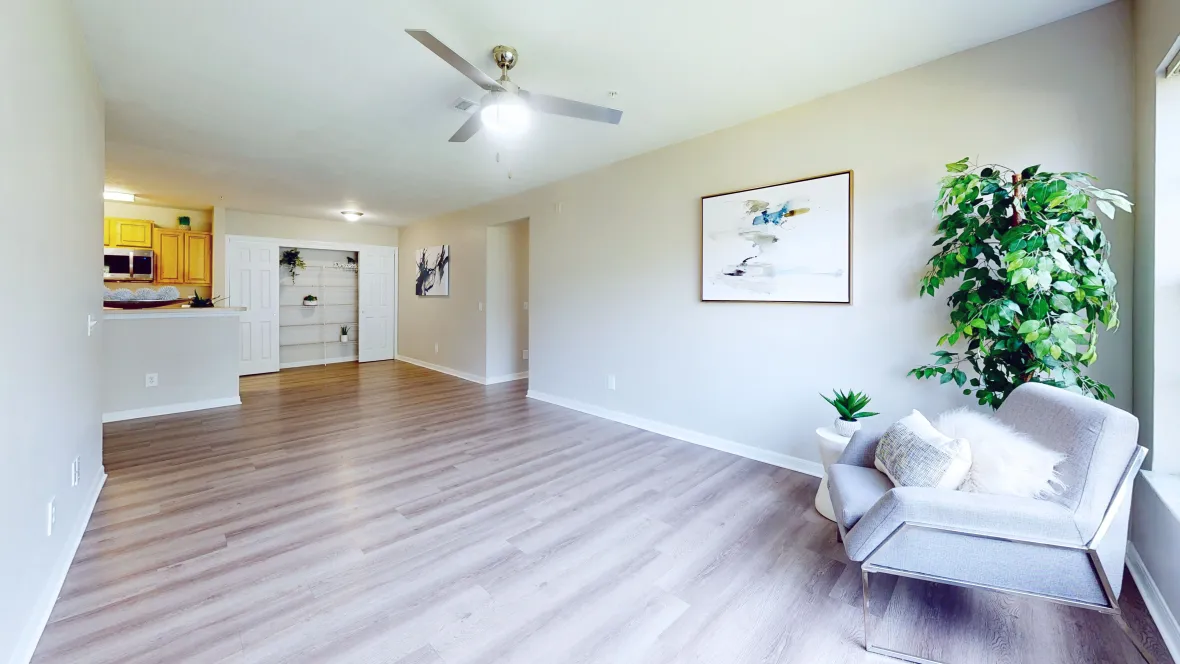 A contemporary ceiling fan adds style and comfort to the modern elegance of the signature living and dining area at Eagle's Pointe. Wood-style flooring sprawling across living, dining and kitchen floors completes the luxurious atmosphere.