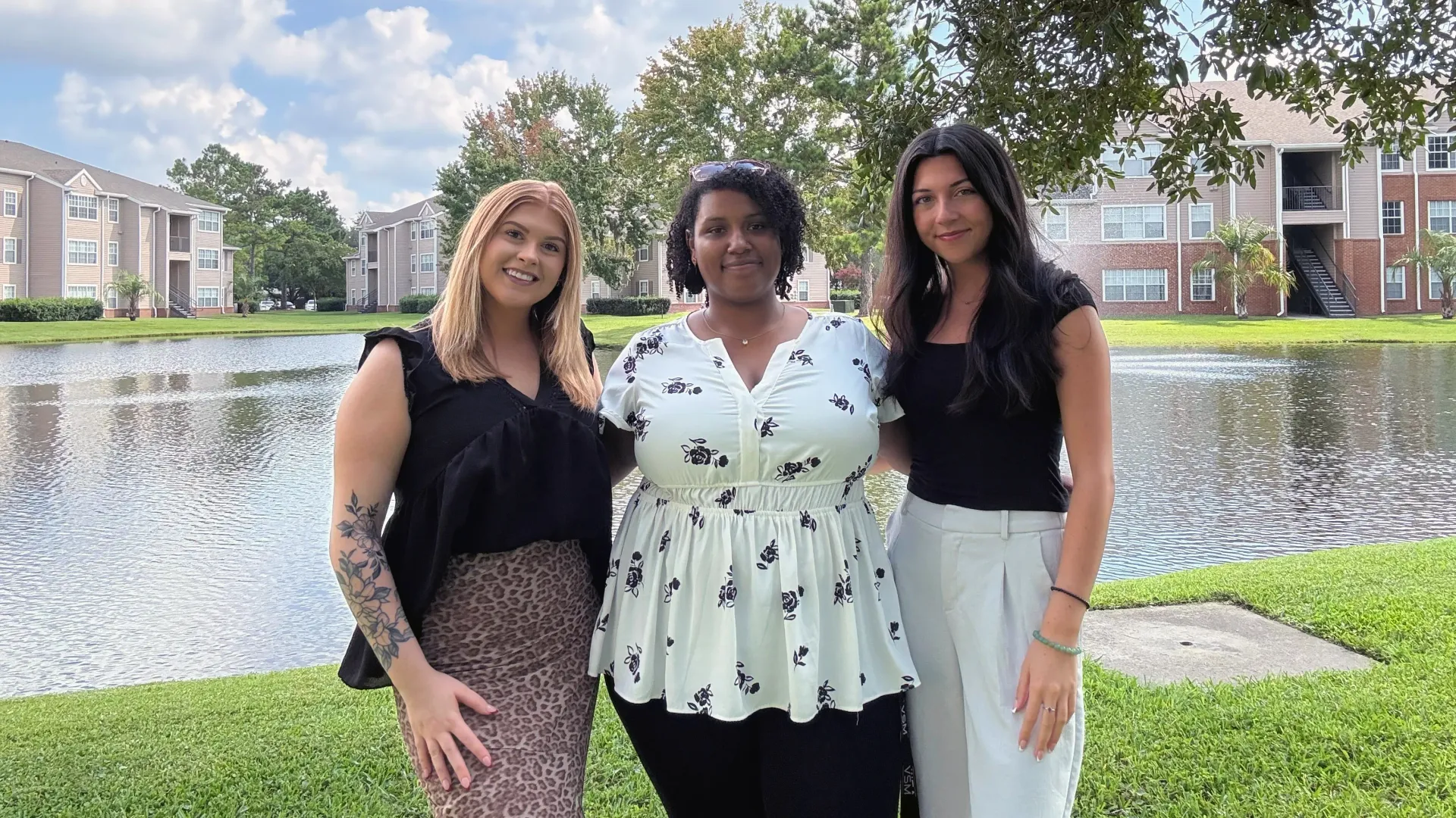 Leasing office staff at Eagle’s Pointe posing outdoors near the lake.