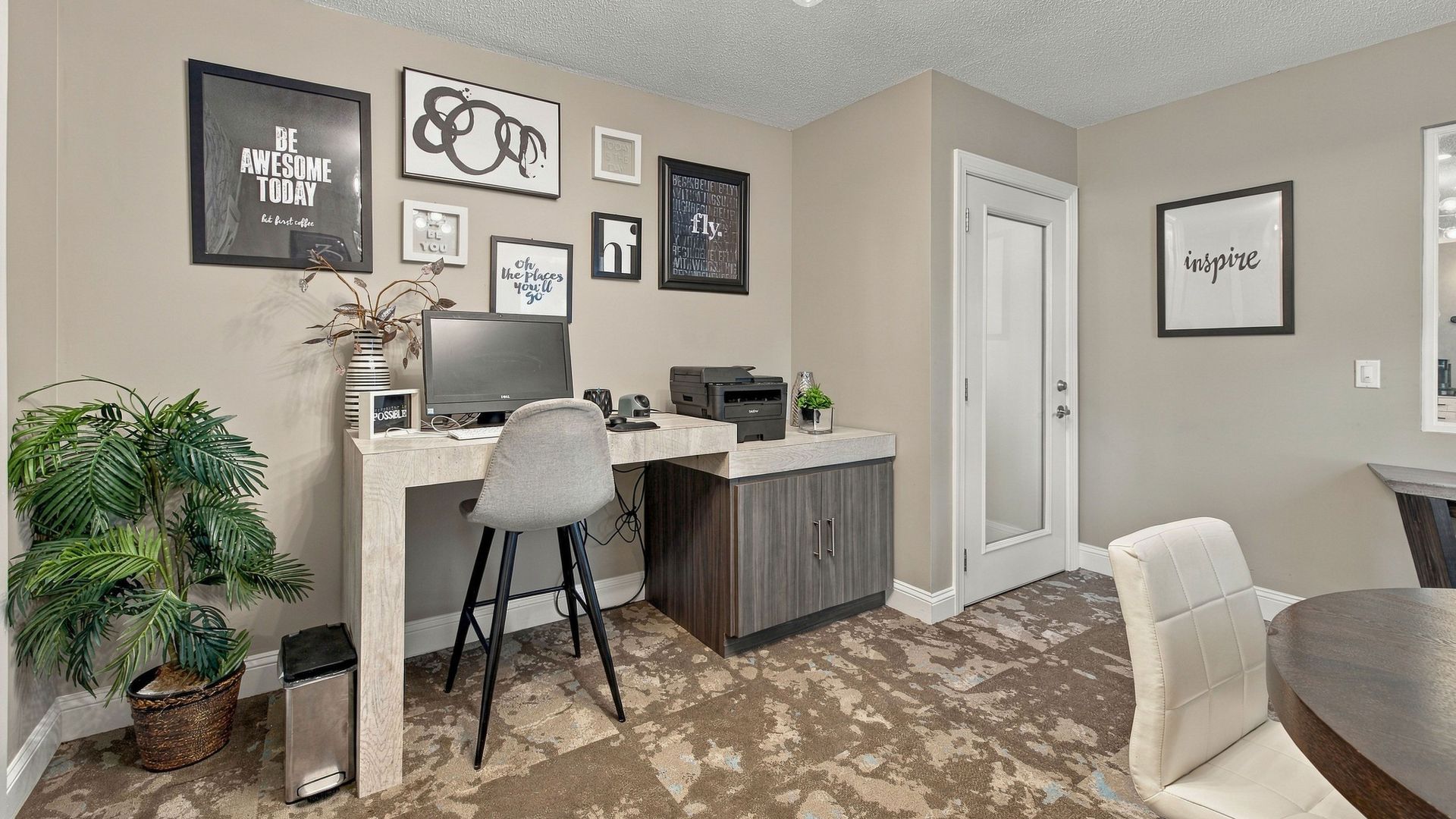 Lanier Landing business center with a desktop computer, printer, workspace, contemporary furnishings, and complimentary printing services.