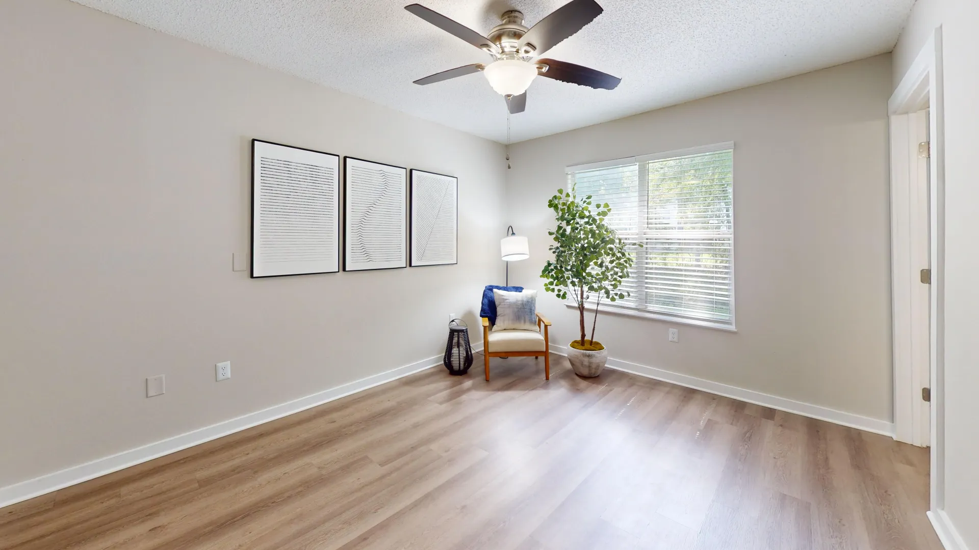 An impeccably maintained bedroom offering tranquility, highlighted by a bright picture window with adjustable window coverings blinds.